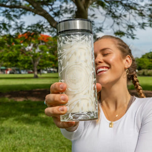 A young lady holds up her Australian Natural Protein Company Glass double walled Drink Bottle for us to see she had opted for a Vanilla flavour Whey-Protein drink